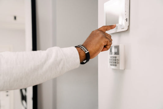 Alarm systems near me hero image with installer setting up smart security