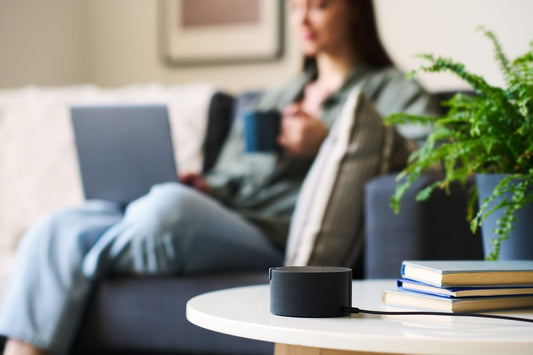 Best speakers for Alexa hero image with smart speaker in a modern living room